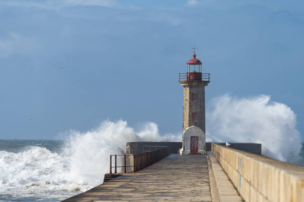 istock Waves hitting the lighthouse on a sunny day 1217218787
