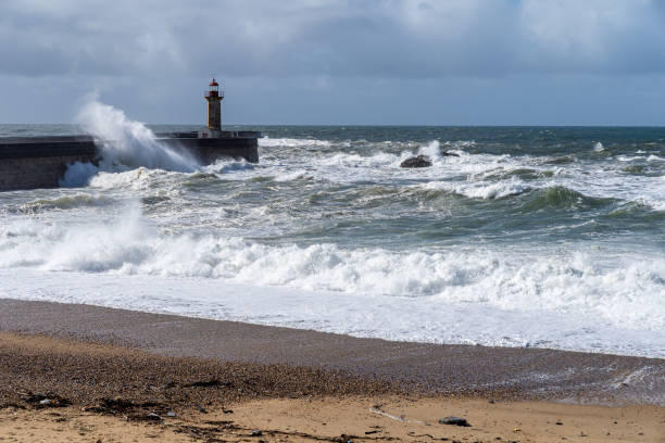 istock Waves hitting the lighthouse on a sunny day 1217218909