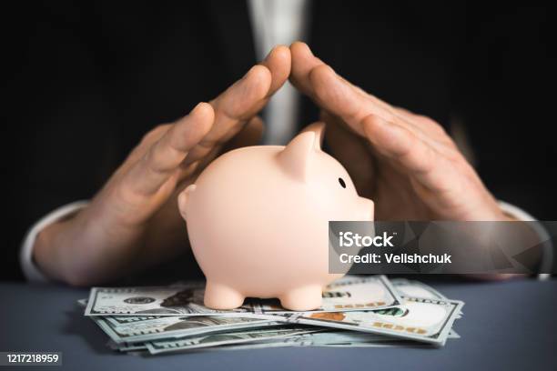 Money Protecting Concept Saving Symbol Closeup Of A Human Hand Protecting Pink Piggy Bank Stock Photo - Download Image Now