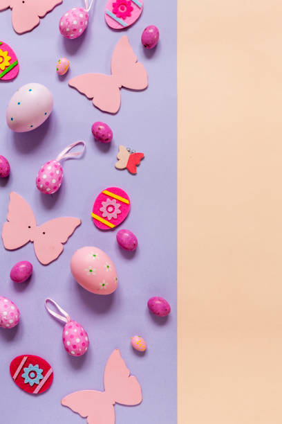 istock Multicolored eggs and varied easter decoration on pastel color paper background 1217220503
