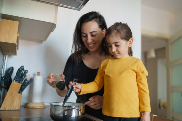 istock Mother and daughter cooking soup together 1217222193