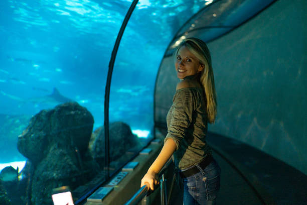 istock Pretty girl walks in aquarium. 1217223140