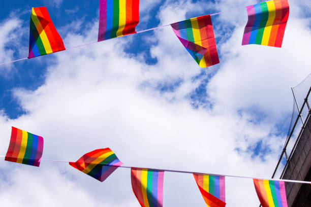 istock Pride flags against blue sky in Chinatown, London, UK 1217224112