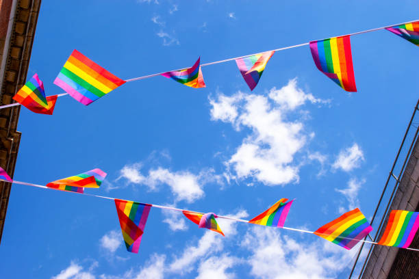 istock Pride flags against blue sky in Chinatown, London, UK 1217224299