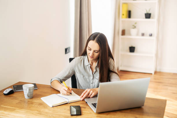 istock Young woman works from home using laptop. 1217224621