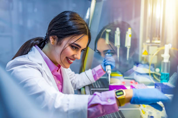 Doing her best to come up with cure Female scientist with equipment and science experiments, Laboratory glassware containing chemical liquid, science research background. Photo of a brown hair student of chemistry working in laboratory. Scientist with dropper working at the laboratory fume cupboard stock pictures, royalty-free photos & images