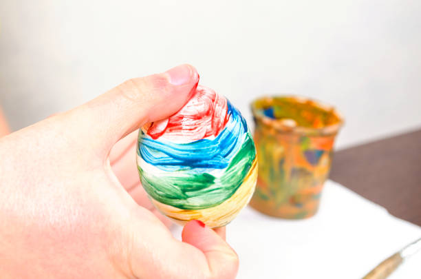 istock Children are preparing for Easter. Coloring eggs with brushes and multi-colored paints 1217231883
