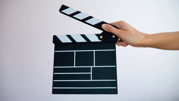 istock Female hand holding classic director empty film making clapperboard. 1217234633