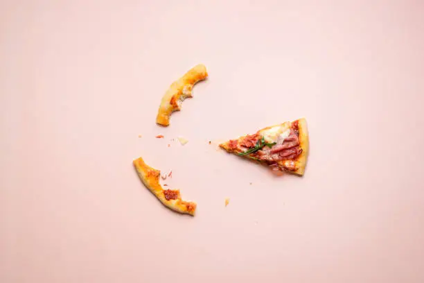 Photo of Ham pizza last piece and crust leftovers. Italian prosciutto pizza slice