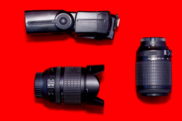 istock Lenses for reflex and flash seen from above, on a red background 1217235061