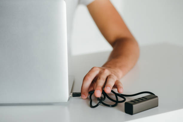 istock Closeup hand connecting usb-hub to laptop 1217235081