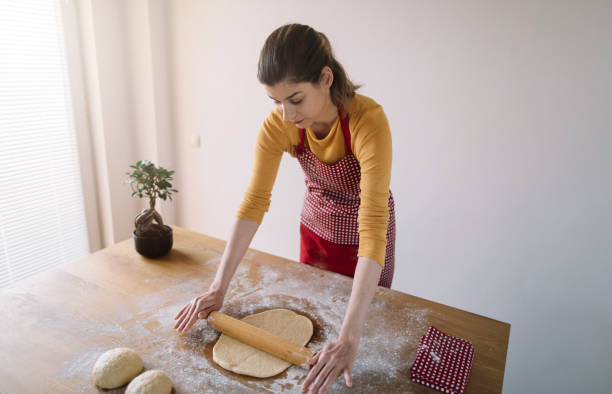 istock Woman kneading bread dough for baking 1217238794
