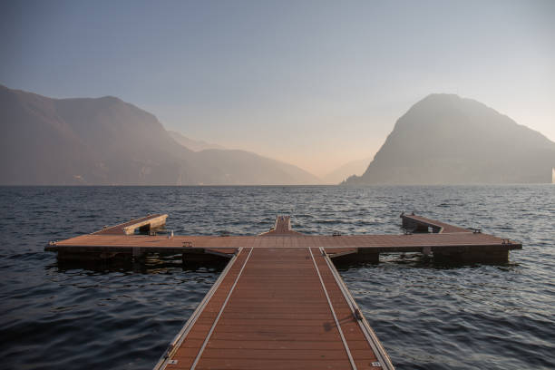 The lake of Lugano with misty sky and mountains at the distance stock photo