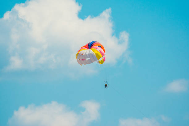 man parachuting above the sea in the sky