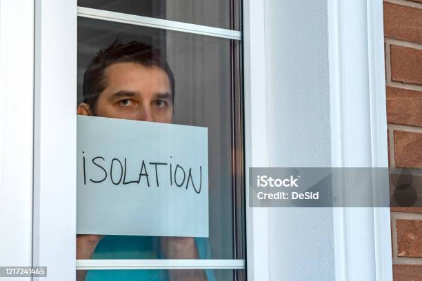 The Man Looks Outside Standing At The Open Window Of His Apartment Staying  At Home During The Epidemic And Quarantine Stock Photo - Download Image Now  - iStock