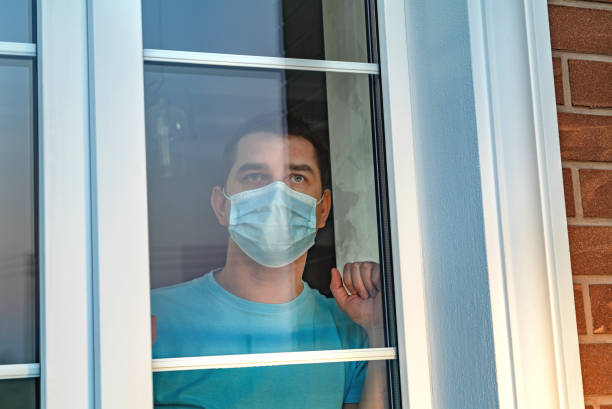istock Man in medical mask stay at home. Self isolation 1217242093