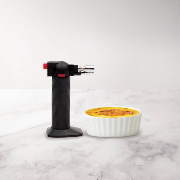 istock Creme Brulee in a cup with a small portable torch 1217242417