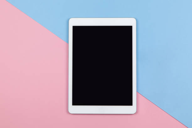 istock Modern female working space, top view. Tablet on two-color background pink and blue, copy space, flat lay. Small business, work from home, using technology, freelance, leisure concept. Horizontal 1217243951