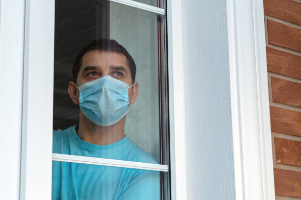 istock Man in medical mask stay at home. Self isolation 1217244828