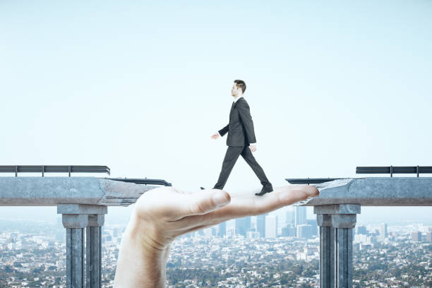 istock Businessman walking over gap in bridge 1217248849