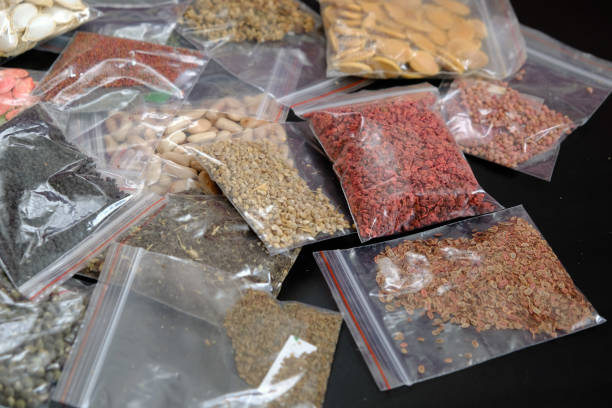 istock organic seeds packed in a wide variety on black ground, 1217251897