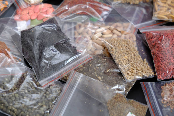 istock organic seeds packed in a wide variety on black ground, 1217251904