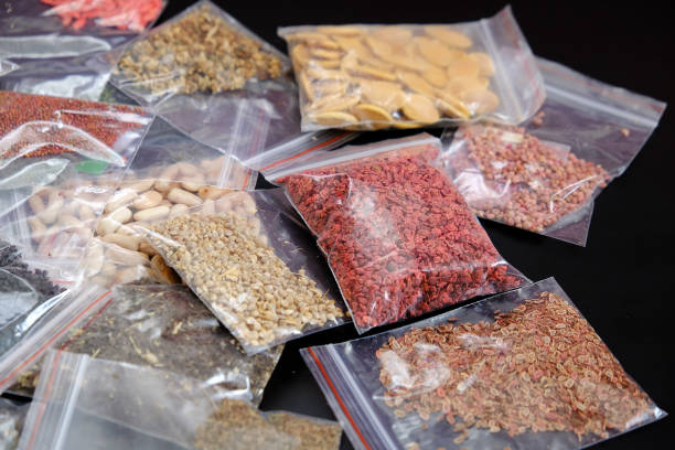 istock organic seeds packed in a wide variety on black ground, 1217251906