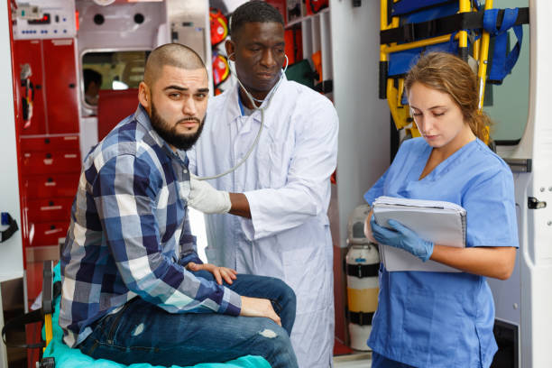 istock Emergency doctors  providing first aid to man in ambulance auto 1217253073