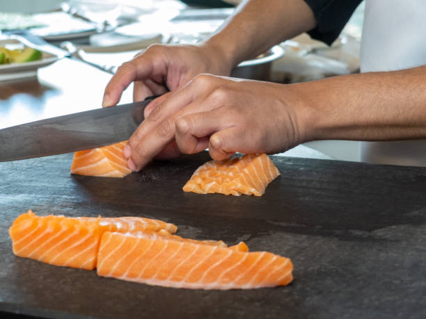 istock Cook preparing salmon for sushi 1217253338