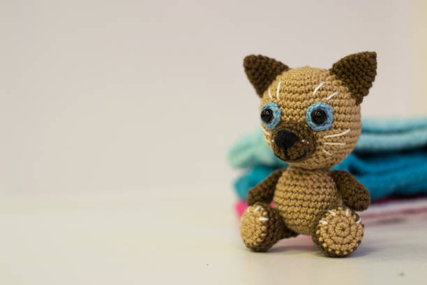 istock Amigurumi brown cat sitting on a white background. Needlework concept. 1217255896