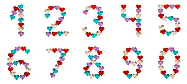 Photo of Isolated Font set of numbers 0-9 made of colorful glass hearts on white and black backgrounds and with sparkles