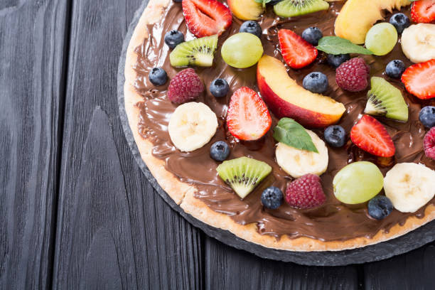istock Fruit pizza with nut nougat cream , fruit and berries 1217259292