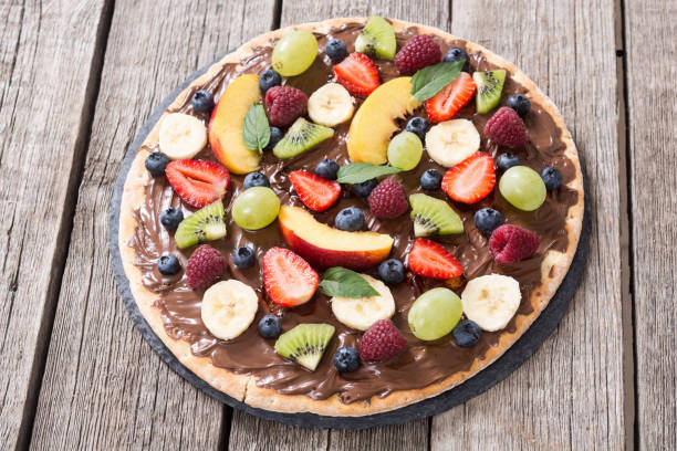 istock Fruit pizza with nut nougat cream , fruit and berries 1217259294