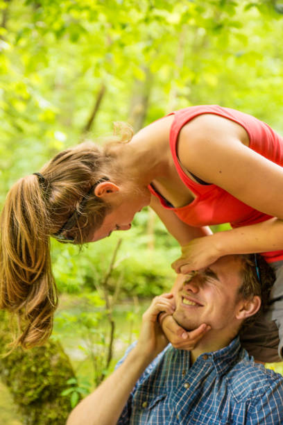 istock Young couple laughing in forest 1217260381