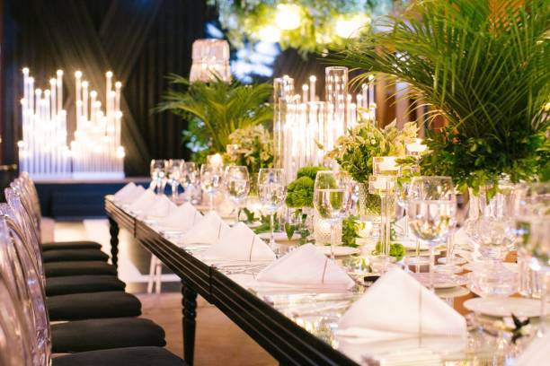 istock Palm tree leaf wedding table. Candles, napkins and mirrored tables. 1217261174