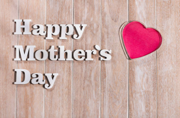 istock Joyful Mother's Day text on rustic white wooden background. greeting card concept. 1217261676