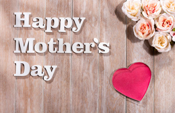 istock Joyful Mother's Day text on rustic white wooden background. greeting card concept. 1217261693