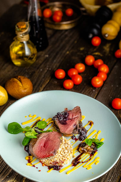 istock rustic wooden background, top and side, on a round plate, fried meat, medium rare well done, with wheat, mushrooms, herbs and vegetables 1217261849