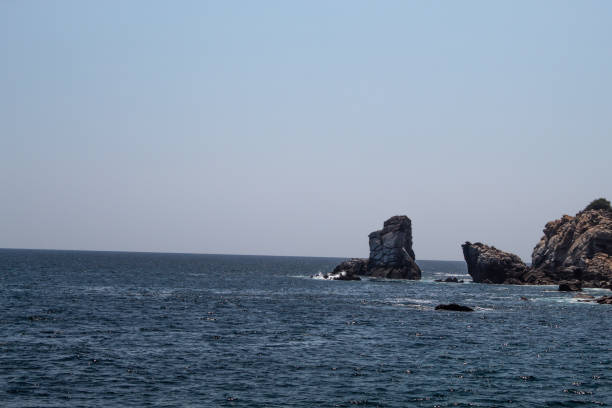 istock Blue ocean in huatulco bay and rock formations 1217262680
