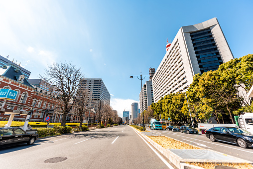 Tokyo, Japan - April 1, 2019: Ministry of Justice building by Imperial palace during spring day wide angle view of street road with traffic cars