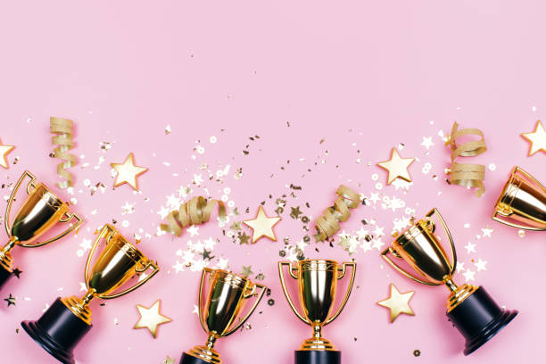istock Winner cups with confetti and sparkles 1217265005
