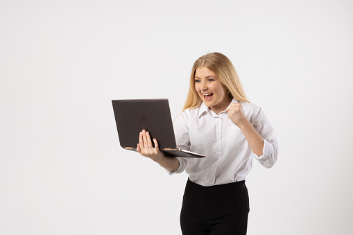 female businesswoman with laptop and exciting and congratulate posture