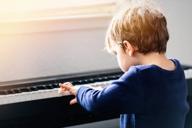 istock Little boy learning how to play piano during the Covid-19 lockdown 1217267272