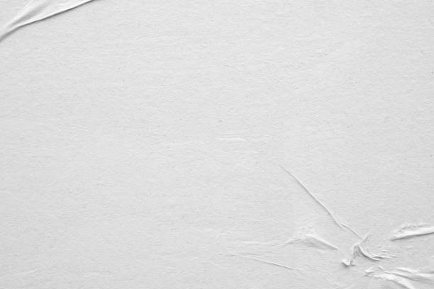 istock Blank white crumpled and creased paper poster texture background 1217268283