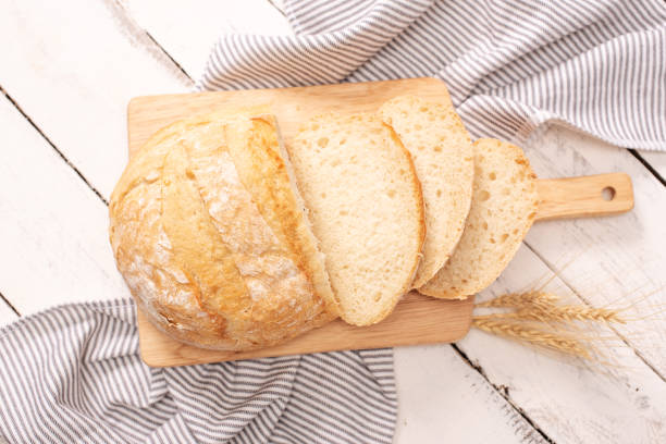 istock Fresh bread on wooden table. Top view with space for your text 1217268917