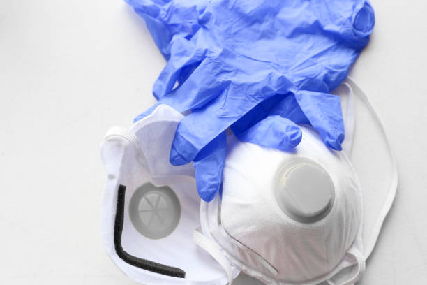 istock blue latex gloves and white protective face mask 1217274249