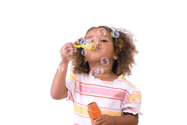 menina mandar bolhas no fundo branco - bubble child bubble wand blowing imagens e fotografias de stock