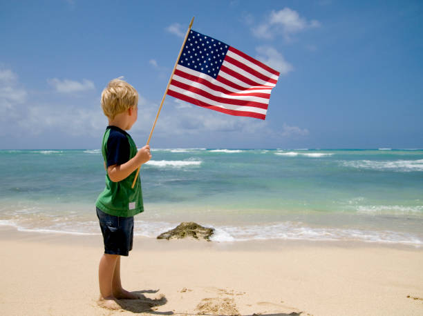istock Boy with the American Flag on a Beach 121728136