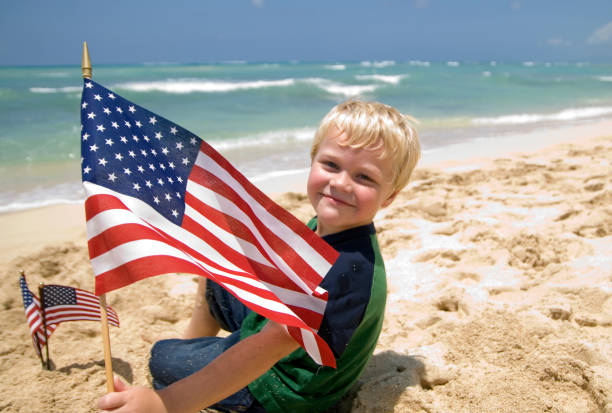 istock Boy with American Flags on a Beach 121728198