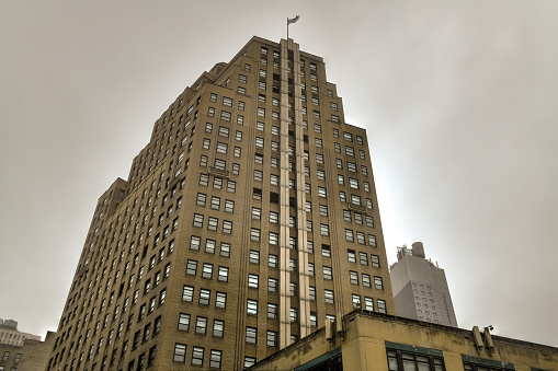 Art Deco skyscraper in midtown Manhattan, New York City on a cloudy day.